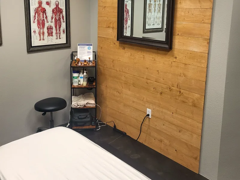 Treatment table against the cedar accent wall with supply cart and stool, Lake Mary, FL
